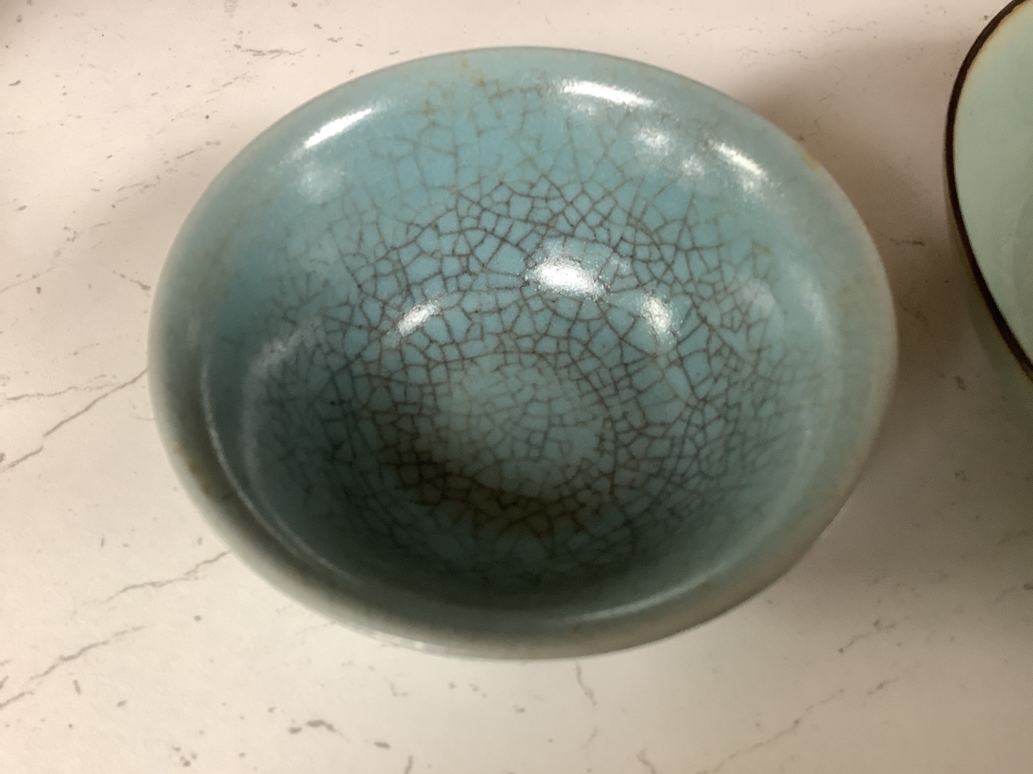 A Chinese celadon bowl and a teabowl, diameter 15cm